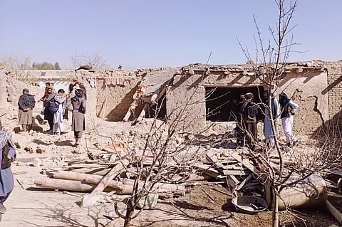 Locals inspect the site of a cross-border attack by the Pakistani army in Afghanistan's eastern Paktika province, Saturday, Oct. 18, 2025.