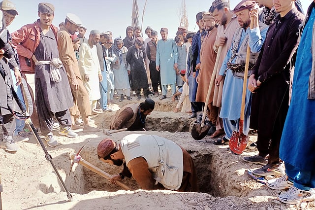 Locals dig graves for people killed in a cross-border airstrike by the Pakistani army in Afghanistan's eastern Paktika province, Saturday, Oct. 18, 2025.