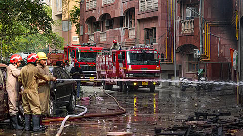 Firefighters try to douse a fire that broke out at Brahmaputra Apartments, in New Delhi, Saturday, Oct. 18, 2025. The apartment complex houses residences of several Lok Sabha and Rajya Sabha MPs.