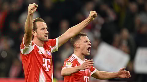 Bayern's Harry Kane, left, and Bayern's Joshua Kimmich celebrate their victory at the Bundesliga soccer match between Bayern Munich and Borussia Dortmund in Munich, Germany, Saturday, Oct. 18, 2025.