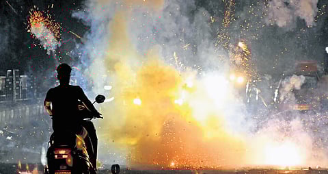 People light firecrackers as part of Diwali festival celebrations, even as pollution levels surged across Delhi-NCR, with Wazirpur recording severe air quality, in New Delhi, Tuesday, Oct. 21, 2025. 