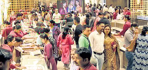 People buy gold from a jewellery store in Bhubaneswar on Dhanteras 