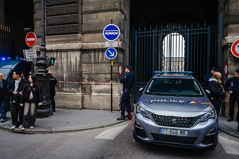 Soldiers patrol as people queue to try to enter the Louvre museum, although it remains closed for the day after Sunday's jewels robbery, Monday, Oct. 20, 2025 in Paris