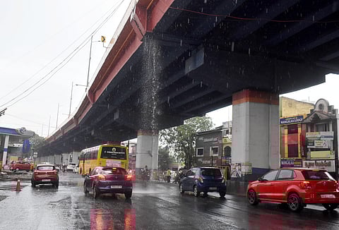 Rainwater from the Tiruchy Road flyover splashes onto vehicles and motorists at Ramanathapuram in Coimbatore during recent showers. 