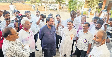 Congress legislator Laxman Savadi (centre) at the counting centre in Belagavi.