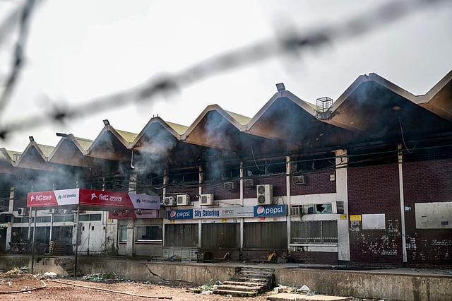 Smoke billows from the fire-damaged cargo terminal of Hazrat Shahjalal International Airport, a day after the blaze in Dhaka on October 19, 2025.