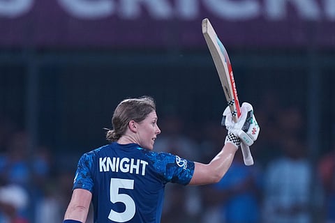 England's Heather Knight celebrates her century during the ICC Women's Cricket World Cup match between India and England in Indore, India, Sunday, Oct. 19, 2025.