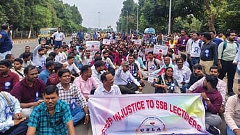 SSB lecturers staging sit-in protest at Mahatma Gandhi Marg on Sunday.