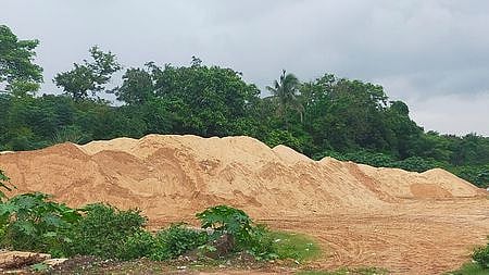 Sand illegally stacked on the embankment of Mahanadi river near Jagatpur.