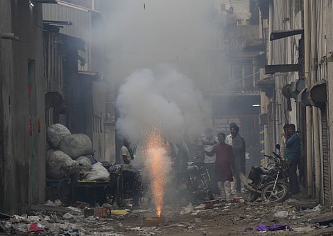 Commuters make their way amid low visibility as air quality deteriorates across Delhi-NCR, Tuesday, Oct. 21, 2025.