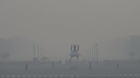 Cracker bursting on Diwali caused a thick layer of smog around Parliament (above) on Tuesday, making visibility low.