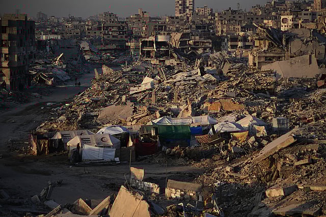 Tents for displaced Palestinians stand amid the destruction caused by the Israeli air and ground offensive in Sheikh Radwan neighborhood in Gaza City, Wednesday, Oct. 22, 2025. 