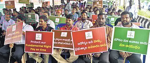 Doctors of ASHA network hospitals stage a protest demanding the clearance of pending bills at Dharna Chowk in Vijayawada on Thursday.