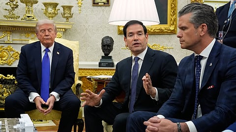 US President Donald Trump (L) and Defense Secretary Pete Hegseth (R) listen as Secretary of State Marco Rubio (C) speaks during a meeting at the Oval Office of the White House, Wednesday, Oct. 22, 2025, in Washington.