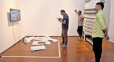 A television, installed at the spot where Hanan Benammar’s art was displayed at the Durbar Hall, playing news reports about the vandalism. The damaged artwork is seen on the floor