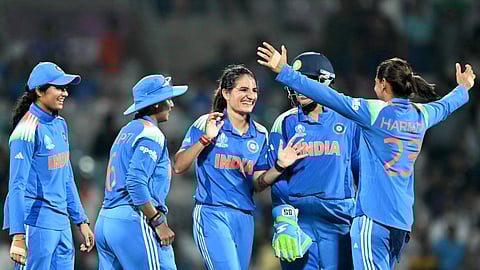 India's Renuka Singh (C) celebrates with teammates after taking the wicket of New Zealand's captain Sophie Devine during the ICC Women's Cricket World Cup 2025 one-day international (ODI) match between India and New Zealand at the DY Patil Stadium in Navi Mumbai on October 23, 2025. 