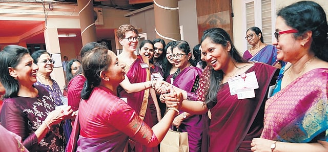 Students, teachers and alumnae of the college, all wearing various shades of purple during Friday’s celebration