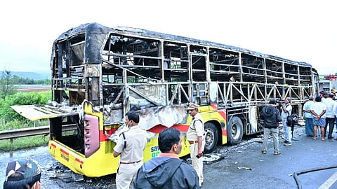 Police personnel investigate the spot after a Hyderabad-bound private bus caught fire following a collision with a two-wheeler, near Chinnatekur in Kurnool district, Andhra Pradesh, Friday, Oct. 24, 2025.