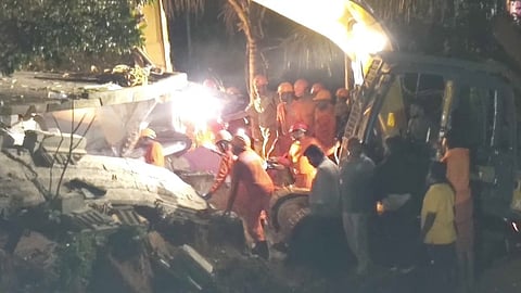 Fire and Rescue Services team and local residents engaged in rescue operations in the collapsed house at Adimali.