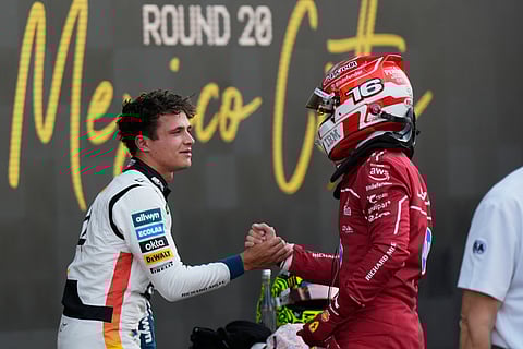 McLaren driver Lando Norris of Britain, left, the pole position winner, is congratulated by Ferrari driver Charles Leclerc of Monaco, who qualified second, during the qualifying session for Formula One Mexico Grand Prix auto race.