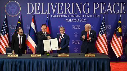 Malaysia's Prime Minister Anwar Ibrahim, left, and US President Donald Trump, right, watch as Thailand's Prime Minister Anutin Charnvirakul, second left, and Cambodia's Prime Minister Hun Manet hold up a document after the ceremonial signing of a ceasefire agreement between Thailand and Cambodia on the sidelines of the 47th Association of Southeast Asian Nations (ASEAN) summit in Kuala Lumpur, Malaysia, Sunday, Oct. 26, 2025. 
