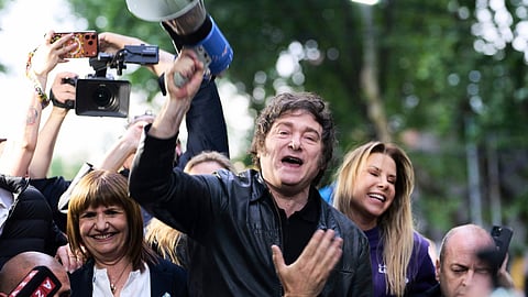 President Javier Milei holds a megaphone while leading a campaign rally ahead of legislative national elections in Tres de Febrero, Buenos Aires province, Argentina, Friday, Oct. 17, 2025.