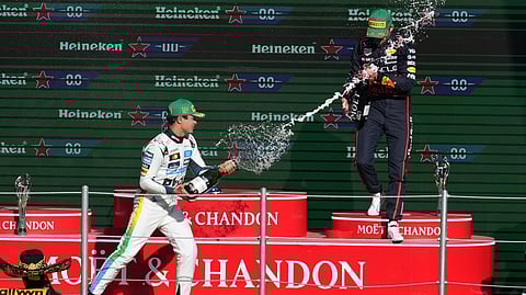 McLaren driver Lando Norris of Britain celebrates on the podium with Red Bull driver Max Verstappen of the Netherlands after wining the Formula One Mexico Grand Prix in Mexico City, Sunday, Oct. 26, 2025.