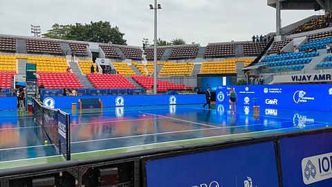 A player assessing the conditions at Court 1 on Monday