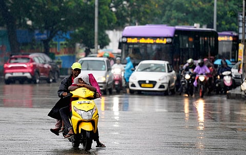 Chennai: Commuters make their way through rain triggered by Cyclone Montha, in Chennai, Tamil Nadu, Monday, Oct. 27, 2025. 