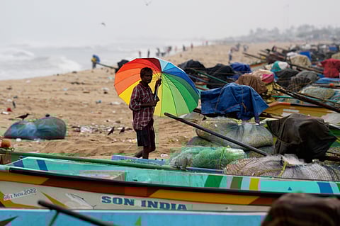 A person looks on as sea waves crash against the shore ahead of the landfall of Cyclone 'Montha', at Marina beach in Chennai, Tuesday, Oct. 28, 2025. 