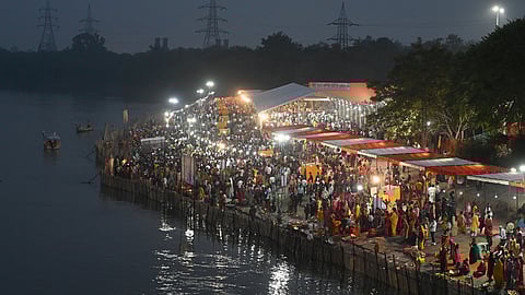 Hindu devotees performing rituals on the banks of river Yamuna, Chhath ghat ITO, on the occasion of Chaiti Chhath Puja in New Delhi on Monday, October 27, 2025.