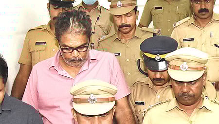 Police escort Murari Babu, a Travancore Devaswom Board employee accused in the alleged Sabarimala gold theft case, from the court.