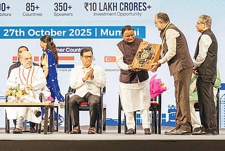 Chief Minister Mohan Charan Majhi receiving a commemorative plaque at the inaugural session of IMW 2025 event in Mumbai