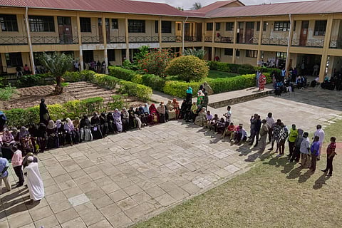 People wait to cast their votes during the general elections at Mpendaye polling station in Zanzibar, Tanzania, Wednesday, Oct. 29, 2025. 