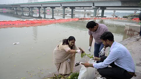 Delhi Chief Minister Rekha Gupta participates in the cleanliness drive at Vasudev Ghat Yamuna river a day after Chhath puja in New Delhi on Tuesday.