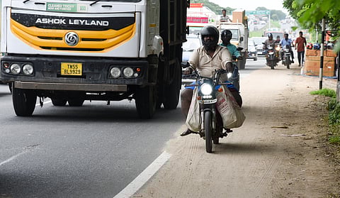 A biker riding along Sanjeevi Nagar in Tiruchy. Motorists express fear that the fine sand deposit would cause them to slip and fall.