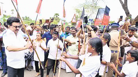 Chief Minister MK Stalin interacts with students and tries his hand at Silambam during his visit to Tenkasi on Wednesday.