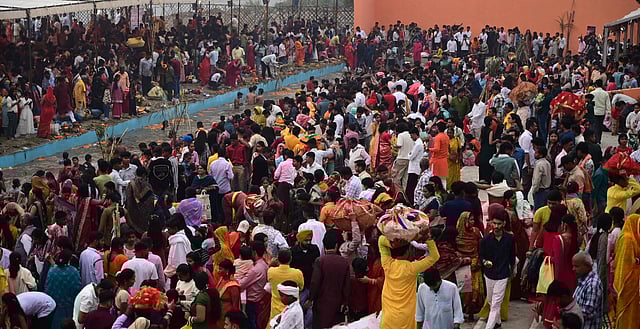 People perform rituals in the Yamuna river on the last day of the Chhath Puja festival celebrations, at ITO, in New Delhi, Tuesday.