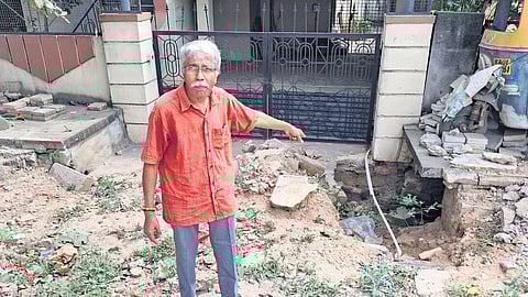 Senior citizen Mahalingam shows how the incomplete GBA whitetopping work on HBR Main Road has made it difficult for him to even come out of his house.