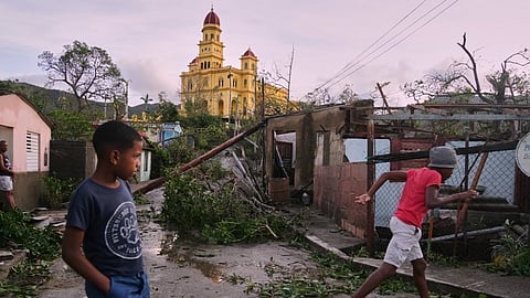 Boys walk in El Cobre, Cuba, in the aftermath of Hurricane Melissa on Wednesday, Oct. 29, 2025.