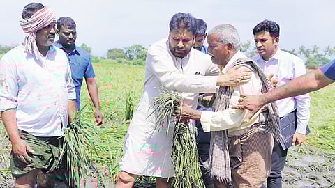 Deputy CM Pawan Kalyan consoling a farmer during his inspection of a cyclone-hit field in Avanigadaa constituency on Thursday.