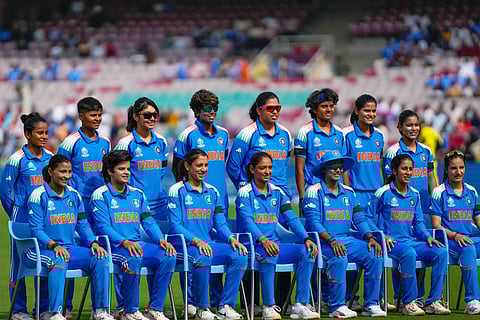 India's players pose for a group photo wearing black armbands before the start of the ICC Women's Cricket World Cup cricket semi final match between India and Australia at DY Patil Stadium in Navi Mumbai,