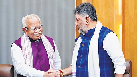Deputy Chief Minister DK Shivakumar greets Union minister Manohar Lal Khattar in Bengaluru on Thursday.