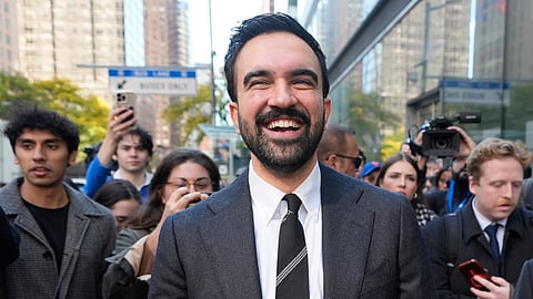New York City mayoral candidate Zohran Mamdani tries to talk to pedestrians while surrounded by reporters in New York, Monday, Oct. 27, 2025.