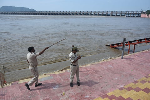 Police personnel deployed at a bathing ghat of Krishna river in Vijayawada on Thursday. 