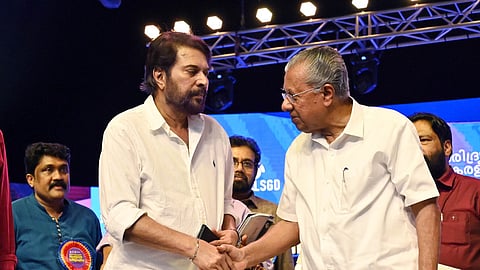 Actor Mammootty and Chief Minister Pinarayi Vijayan interact at the Extreme Poverty Eradication declaration event at Central Stadium in Thiruvananthapuram on Saturday