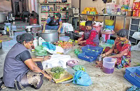 Women at Sign and Dine in Puducherry prepare meals together, turning their kitchen into a space for empowerment and opportunity.