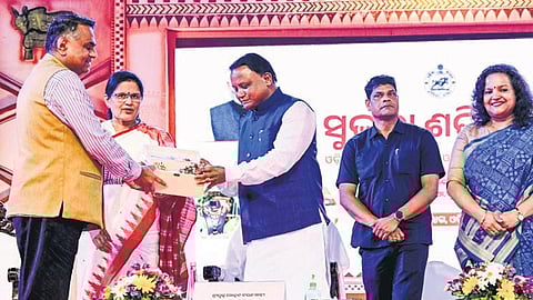 Mission Shakti commissioner-cum-principal secretary Girish SN presenting a memento to Chief Minister Mohan Charan Majhi | express
