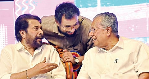 Actor Mammootty, MP John Brittas and Chief Minister Pinarayi Vijayan interact at the Extreme Poverty Eradication declaration event at Central Stadium in Thiruvananthapuram on Saturday.
