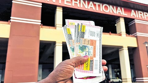 A vendor selling lottery tickets in the parking lot of Kochi airport 